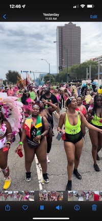 a group of people in colorful costumes walking down the street