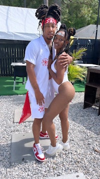 a man and woman posing for a photo in a white bikini