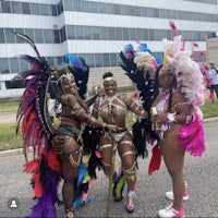 three women in colorful costumes posing for a photo