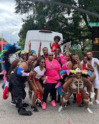 a group of people posing for a photo in front of a van