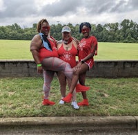 three women in red outfits posing for a picture