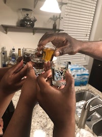 a group of people toasting in a kitchen