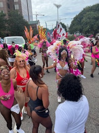 a group of people in colorful costumes walking down the street