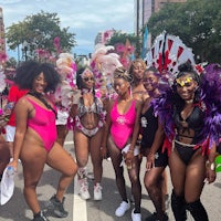 a group of women in colorful costumes posing for a photo